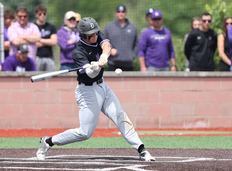Downers Grove North's Jimmy Janicki (16) makes contact with the ball during the IHSA Class 4A baseball regional final between Downers Grove North and Hinsdale Central at Bolingbrook High School on Saturday, May 27, 2023.