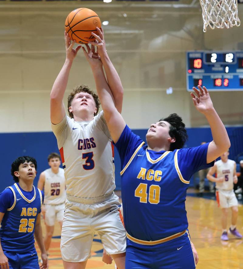 Genoa-Kingston's Jack Peterson and Aurora Central Catholic's Braden Dillon go after a rebound Monday, Feb. 23, 2026, during their IHSA Class 2A regional quarterfinal at Genoa-Kingston High School.