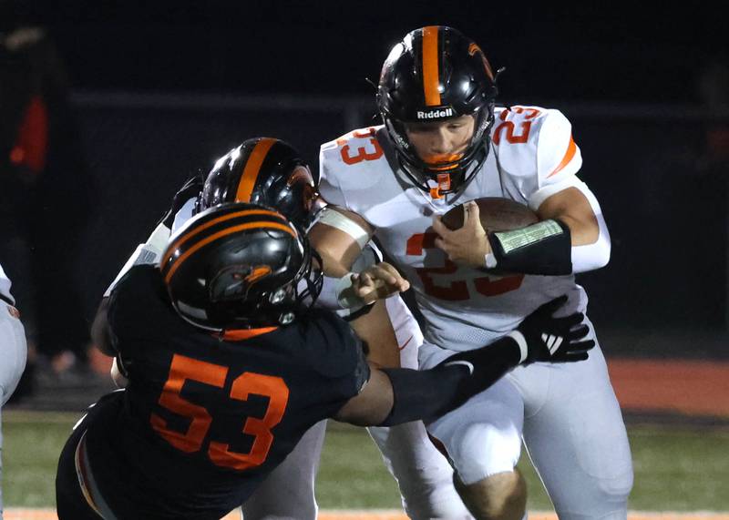 Lincoln-Way West's Jimmy Talley Jr. tries to run through a DeKalb defender during their game Friday, Oct. 3, 2025, at DeKalb High School.
