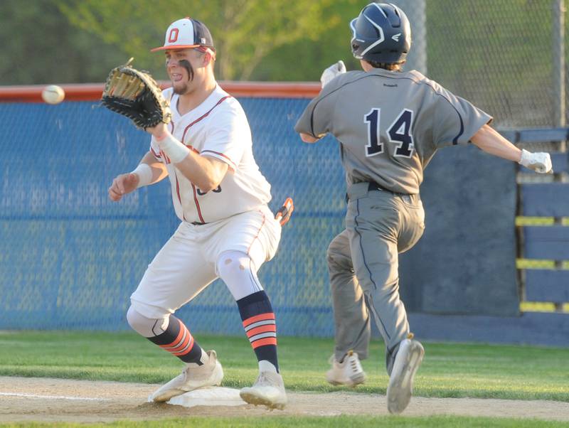 Oswego East's Dylan Kubek (14) beats the throw to Oswego first baseman Cade Duffin during a varsity boys baseball game on Thursday, May12, 2022 at Oswego High School.