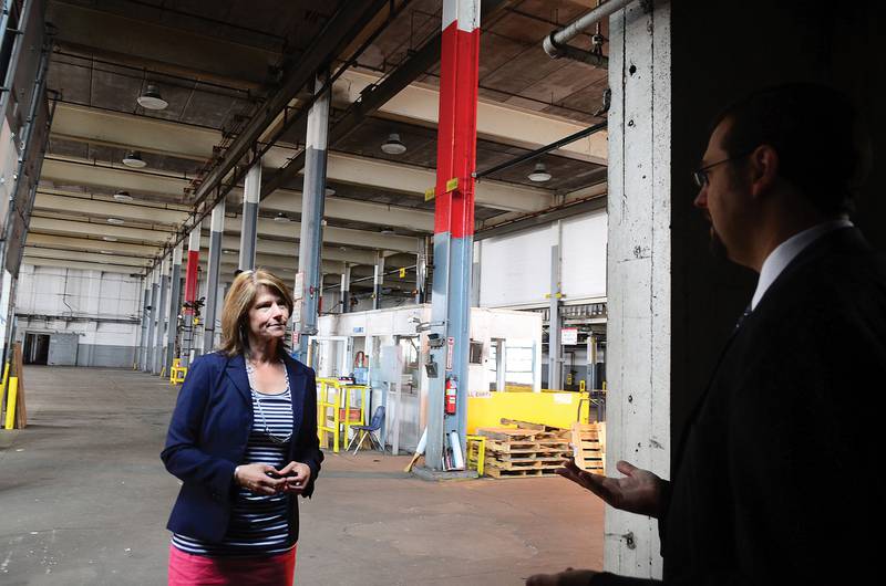 2012 FILE: Cheri Bustos, then as a first-time Democratic candidate for election in the 17th Congressional District, speaks with Sterling City Manager Scott Shumard as they tour the National building along the riverfront. Shumard outlined some of his hopes for the riverfront.