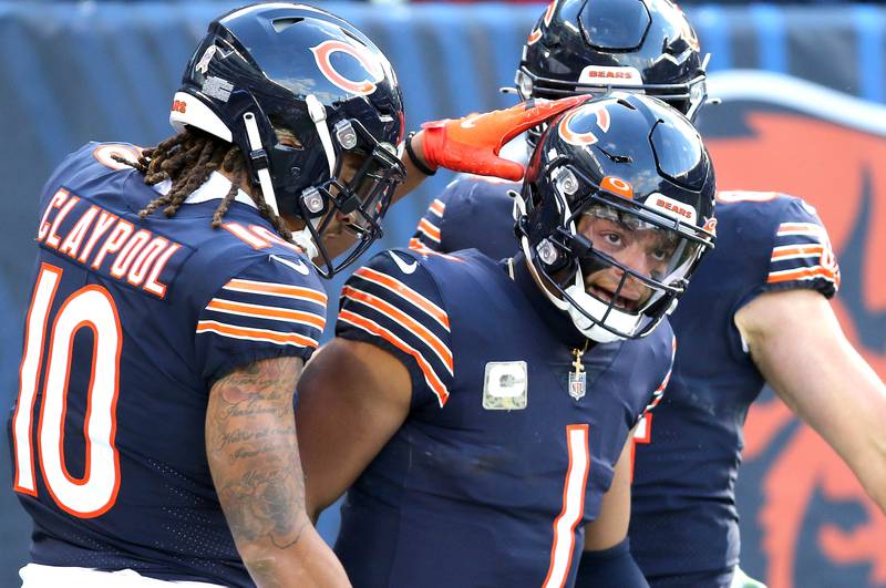 Chicago Bears quarterback Justin Fields gets congratulations from Chicago Bears wide receiver Chase Claypool after a long touchdown run in the fourth quarter of their game Sunday, Nov. 13, 2022, at Soldier Field in Chicago.