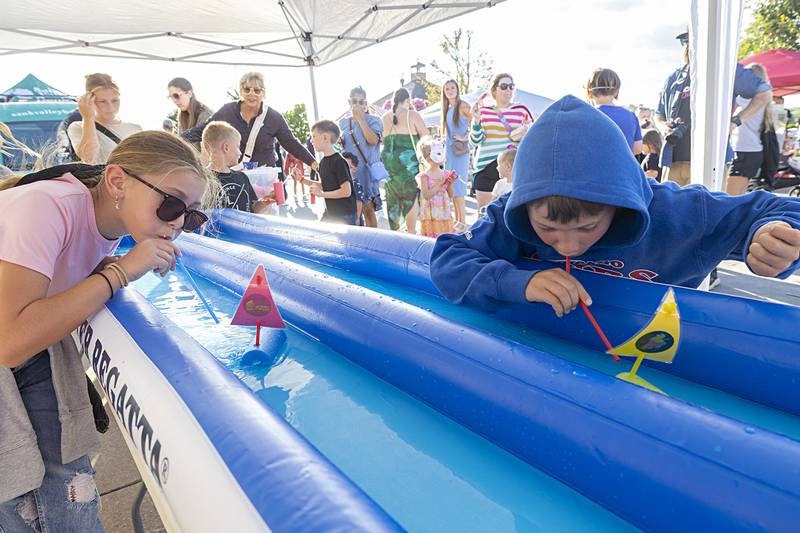 Addison (left), 10, and Cooper Weidman, 7, of Dixon compete in the Raingutter Regatta Saturday, Aug. 10, 2024 at Dixon’s Venetian Night.