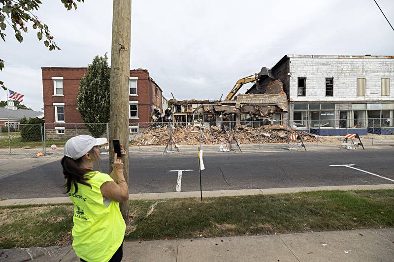 Janet Burke, partner of Patrick Burke takes video of the demolition Tuesday, Sept. 5, 2023 in downtown Sterling.