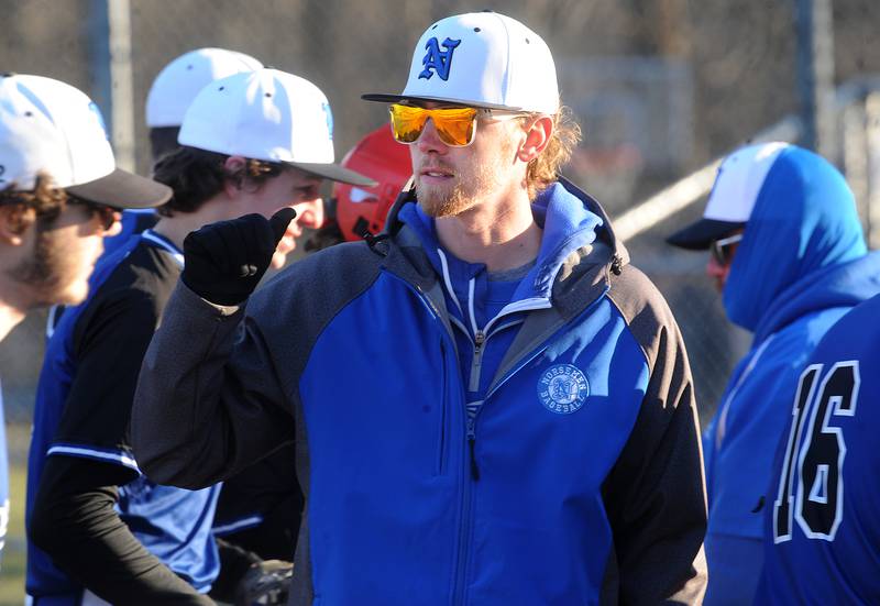 Newark head baseball coach Josh Cooper greets his player during a varsity baseball game against Morris at Newark High School on Wednesday, Mar. 29, 2023.