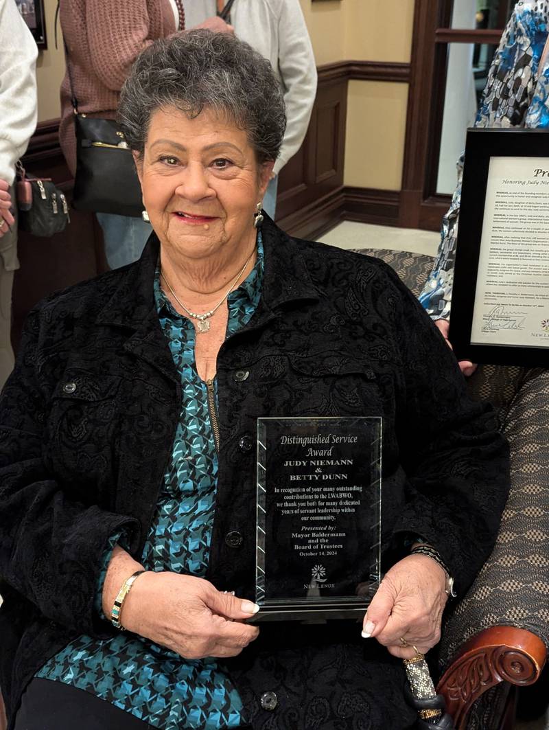 Tim Baldermann, mayor of New Lenox, honored Judy Niemann, a founder of the the Lincoln-way Area Business Women’s Organization with a proclamation a crystal plaque at a recent New Lenox Chamber of Commerce meeting.