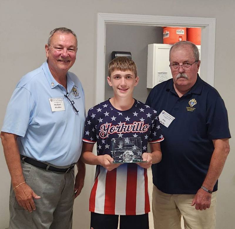 Yorkville Knights of Columbus members Mike Pfeiffer (far left) and Grand Knight Jim Zbella (far right) honor free throw contest champion Andrew Madden (center) at the Council's Aug. 14 meeting.