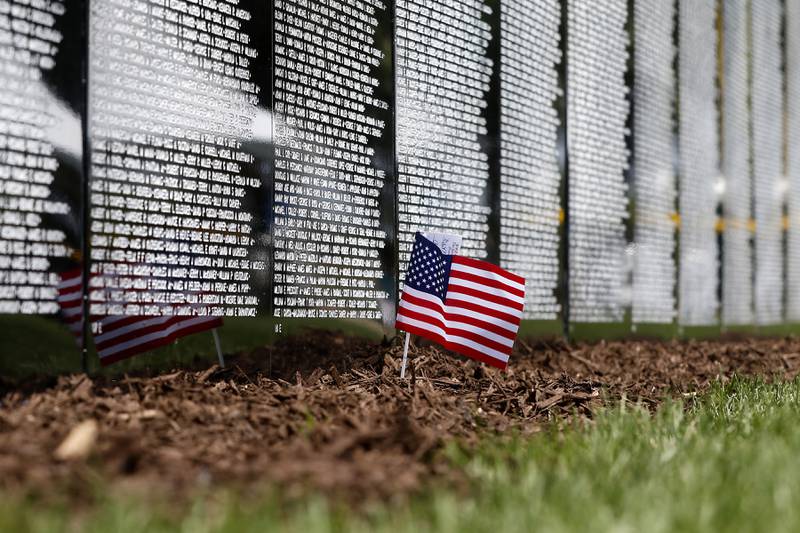 A small American Flag is left Friday, July 14, 2023, at the Vietnam Traveling Memorial Wall at the VFW Post 4600 in McHenry.