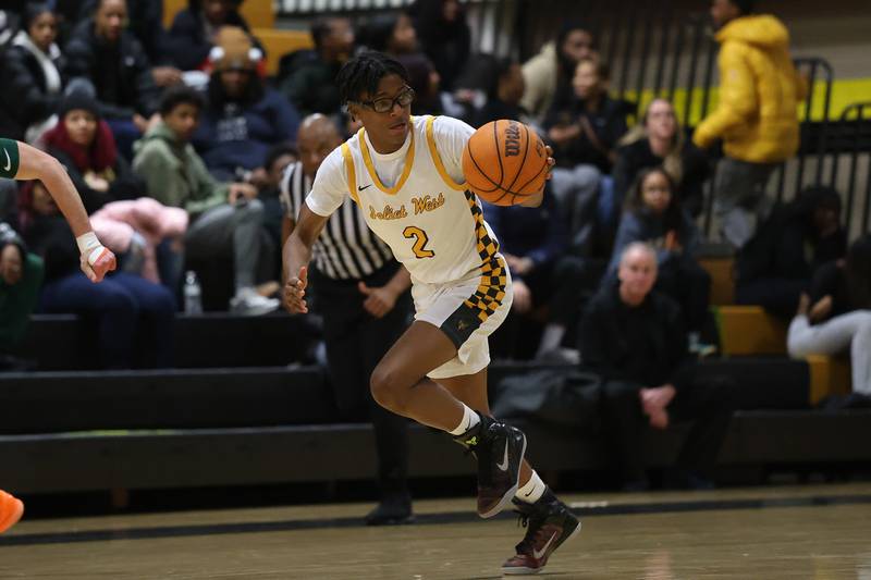 Joliet West’s Elijah Wilson takes the ball up court against Plainfield East on Friday, Dec. 19, 2025 in Joliet.