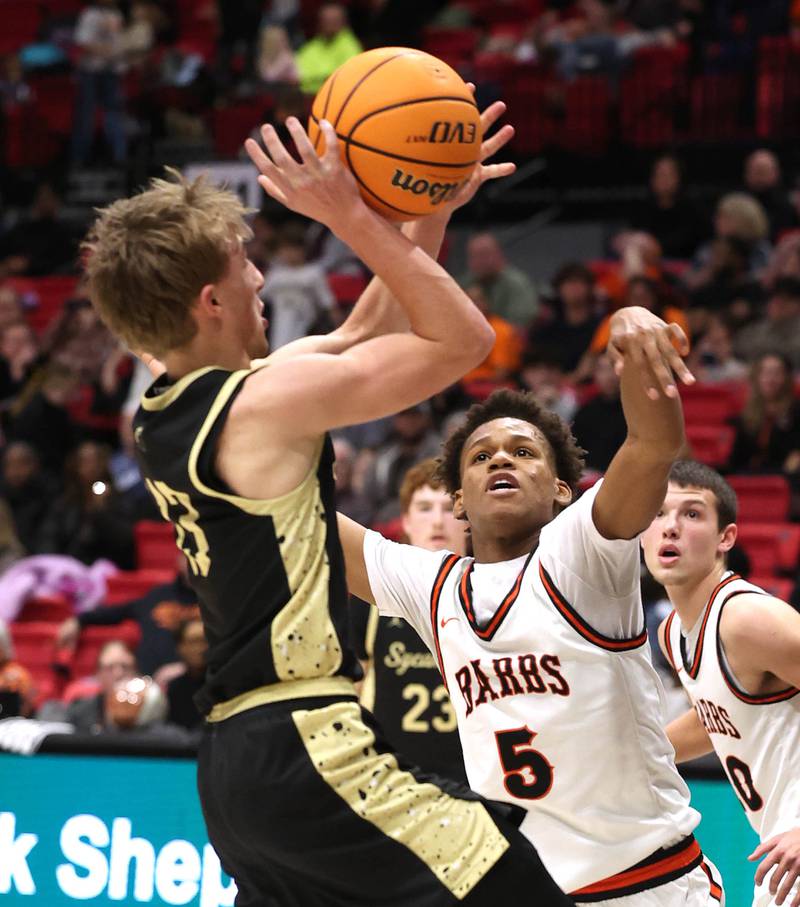 DeKalb's Bryan Miller knocks the ball away from Sycamore's Xander Lewis Friday, Jan. 30, 2026, during the FNBO Challenge at the Convocation Center at Northern Illinois University in DeKalb.
