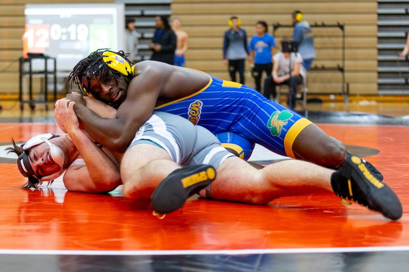 Joliet Central's Charles Walker takes on Colin Dominiak of Plainfield East in the 215-pound match at Plainfield East on Dec. 12, 2024.