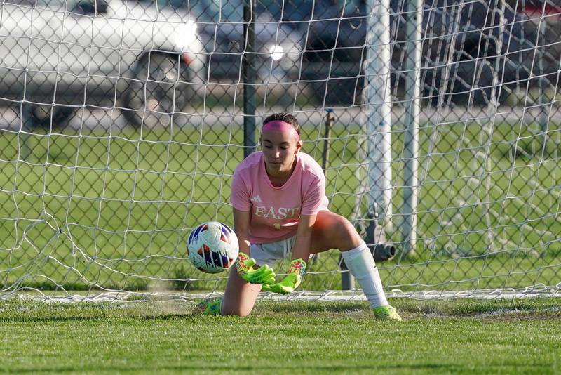 Oswego East's Meeya Widdison (1) makes a save against Oswego during a soccer match at Oswego High School on Tuesday, April 29, 2025.
