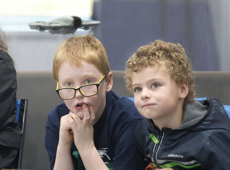 Peter and Joseph Martin of Ottawa, watch a drone fly over their heads during a drone competition on Saturday, Nov. 22, 2025 at the Second Story Teen Center in Princeton. Teams from Bureau, La Salle and Marshall-Putnam counties came together to showcase their flying skills during the event. Second Story Teen Center partnered with the University of Illinois Extension of Bureau, La Salle Marshall and Putnam Counties. Drones and awards were purchased through a grant and donations from Compeer Financial.