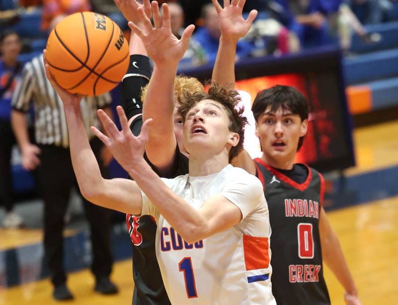 Genoa-Kingston's Kash Sunderlage shoots the ball in front of Indian Creek's Payton Hueber (left) and Cooper Rissman during their game Friday, Jan. 2, 2026, at Genoa Kingston High School.