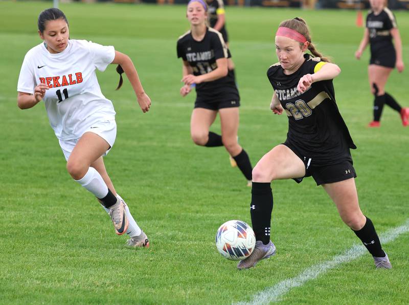 Sycamore's Cortni Kruizenga saves the ball from going out-of-bounds with DeKalb's Ashley Hernandez in pursuit Thursday, May 7, 2026, during their game at Sycamore High School.