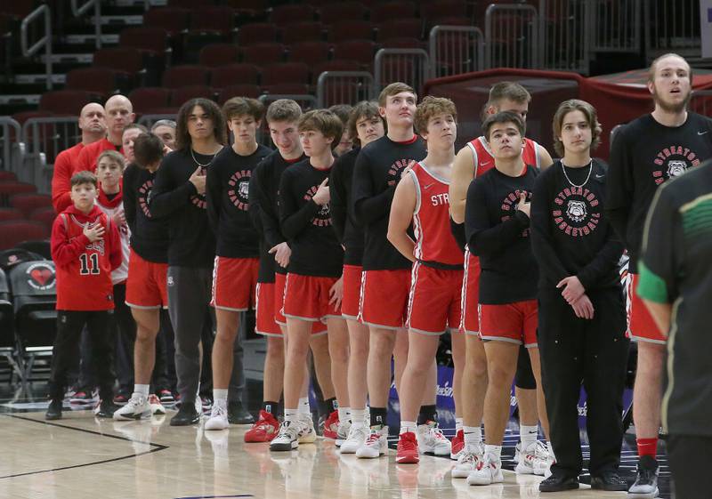 Members of the Streator boys basketball team stand for the National Anthem during a game on Tuesday, Dec. 21, 2023 at the United Center in Chicago.