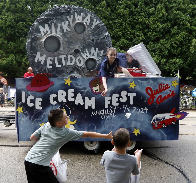 Ice cream is tossed to children from the Julie Ann’s Frozen Custard float on Sunday, July 7, 2024, during Crystal Lake’s annual Independence Day Parade on Dole Avenue in Crystal Lake. This year’s parade feature close to 100 units.