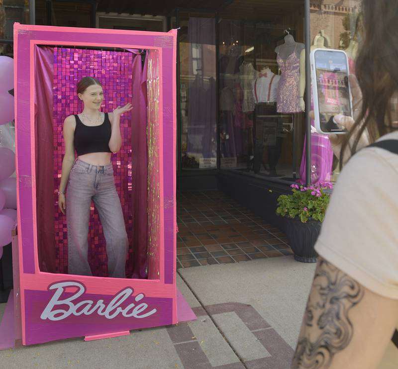 Claire Small has her photo taken in a Barbie Box by her friend Jade Prebainca in front of 
Unique Formal Wear Saturday during the annual Scarecrow Festival in Ottawa.