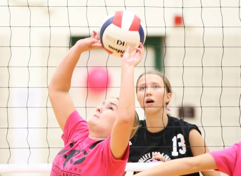 L-P's Emma Jereb sets the ball in the air as Ottawa's Ayla Dorsey eyes the ball during Volley for a Cure night on Tuesday, Oct. 1, 2024 at AJ Sellett Gymnasium.