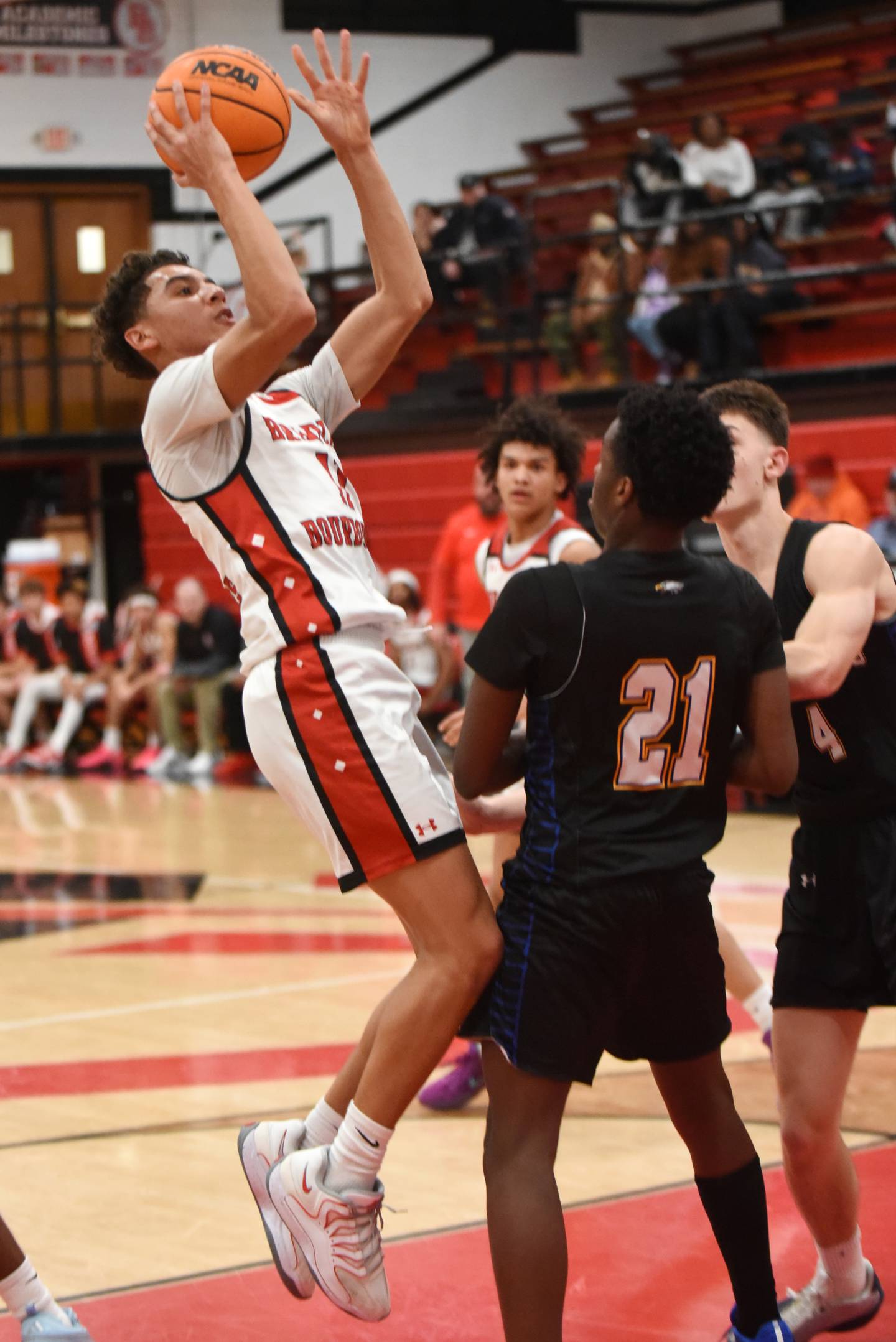 Bradley-Bourbonnais' Trey Lawrence takes a shot in front of a pair of Sandburg defenders during a game at Bradley-Bourbonnais Tuesday, Feb. 3, 2026.