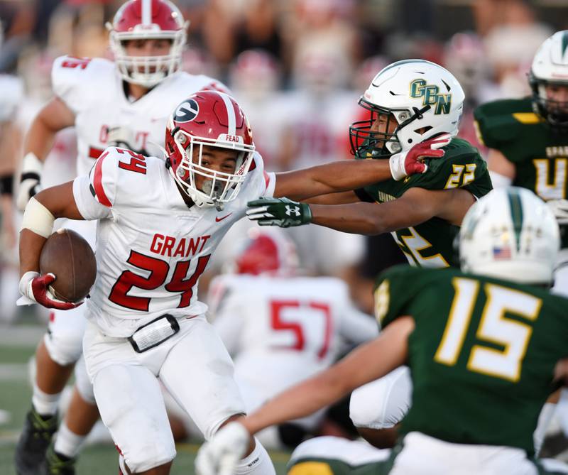 Joe Lewnard/jlewnard@dailyherald.com
Grant’s Tyler Zdon, left, carries the ball as he goes against Christopher Thompson during Friday’s game in Northbrook.