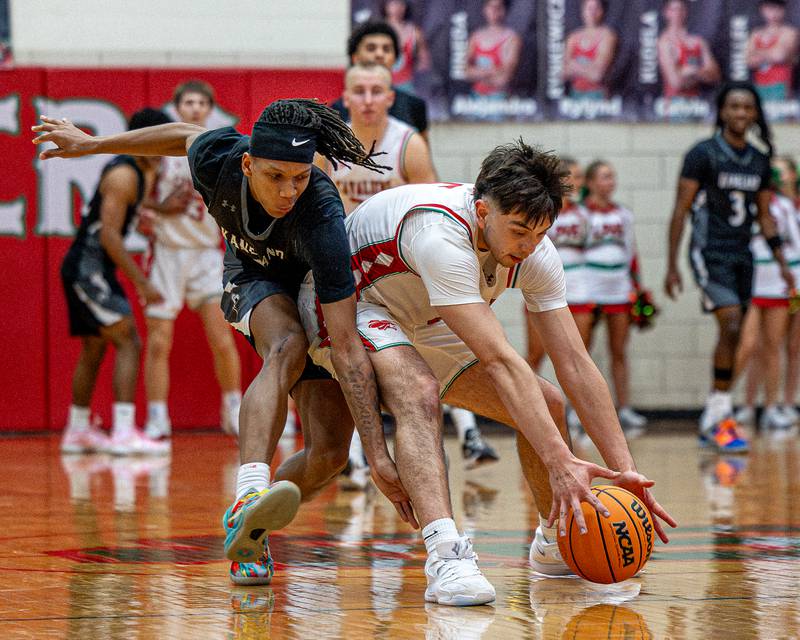 Erick Sotelo (5) of LaSalle-Peru reaches for loose ball after Kaneland's Isiah Gipson (2) striped it of his possession on Friday, Feb. 20, 2026 in Sellett Gymnasium at L-P High School.