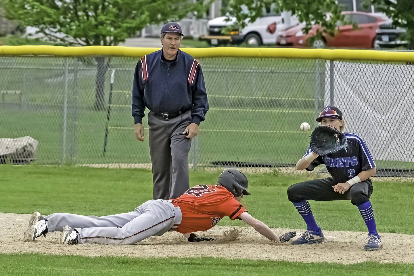 Newman first baseman Grant Koerner waits for the pickoff throw as Forreston's Brendan Greenfield slides back safely during the 1A Newman Regional final on Saturday in Sterling.