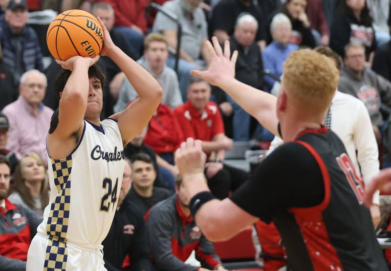 Marquette's Matthew Graham lets go of a shot over Indian Creek's Isaac Willis during the Class 1A Sectional game on Friday, March 6, 2026 at Amboy High School.
