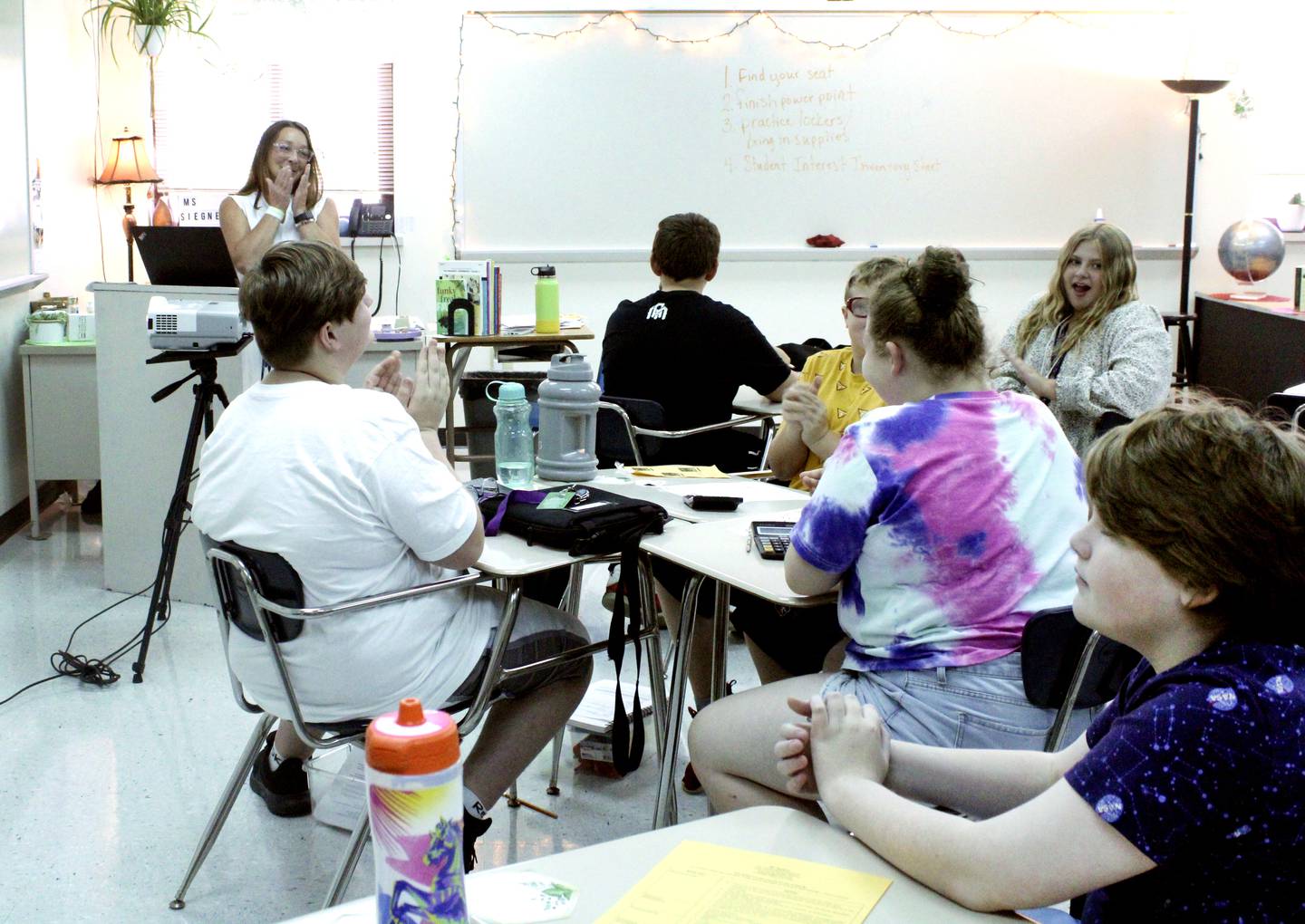 Special education teacher Tracy Siegner is gleefully surprised when one of her students expresses a desire to become a better reader and the whole class breaks out into spontaneous supportive applause during her first day teaching at West Carroll Middle School on Wednesday.