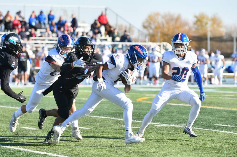 Glenbard South's Isaiah Gray runs the ball Saturday during the Raiders' 42-0 loss to Kankakee in the first round of the IHSA Class 6A playoffs.