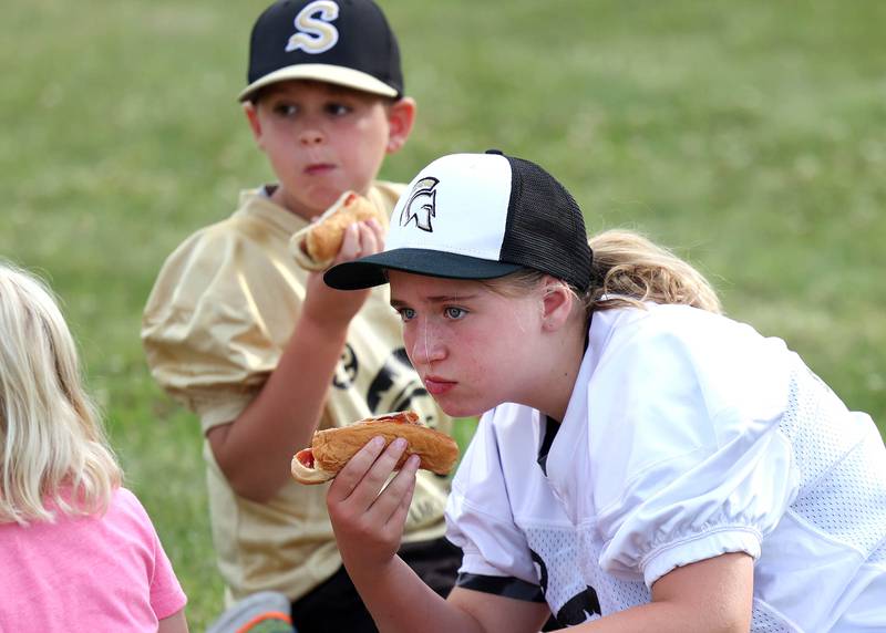 Dominic Amato, 8, and his sister Grace, 10, from Sycamore, enjoy hotdogs at the tailgate Friday, Aug. 30, 2024, before DeKalb, Sycamore football game in the the FNBO Challenge at Huskie Stadium at Northern Illinois University.