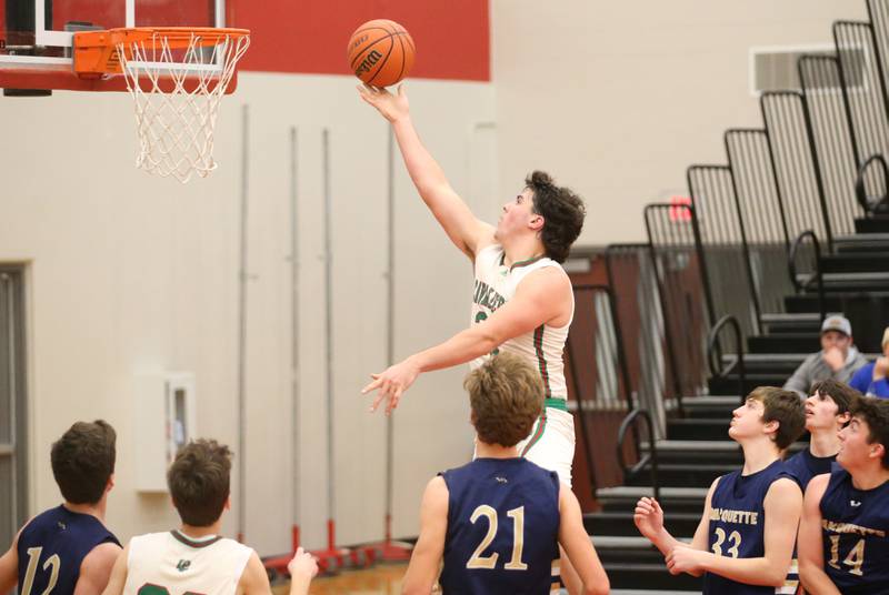 L-P's Josh Senica runs in for a layup against Marquette during the 49th annual Colmone Classic Tournament on Wednesday, Dec. 6, 2023 at Hall High School.