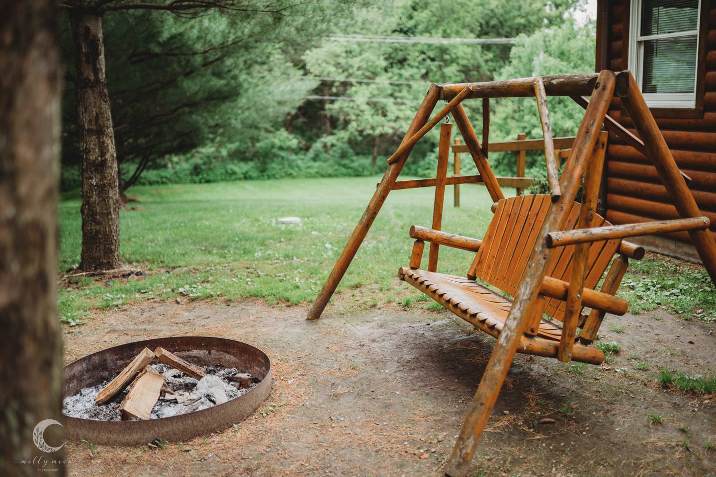 An outdoor firepit and swing at the Cabins at Pine Creek near Oregon, Illinois.