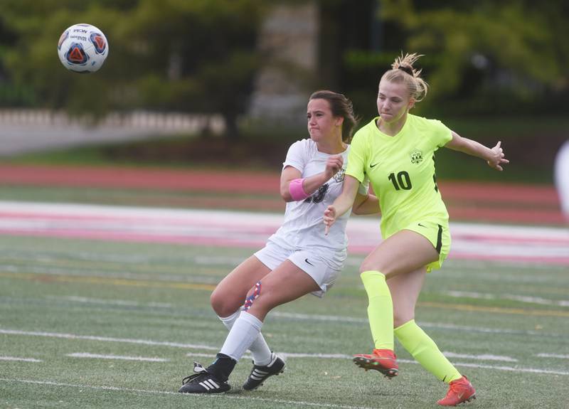 Richmond-Burton's Margaret Slove (10) sends the ball past Quincy Notre Dame's Lauryn Peters during Saturday’s IHSA Class 1A state girls soccer championship game at North Central College in Naperville.