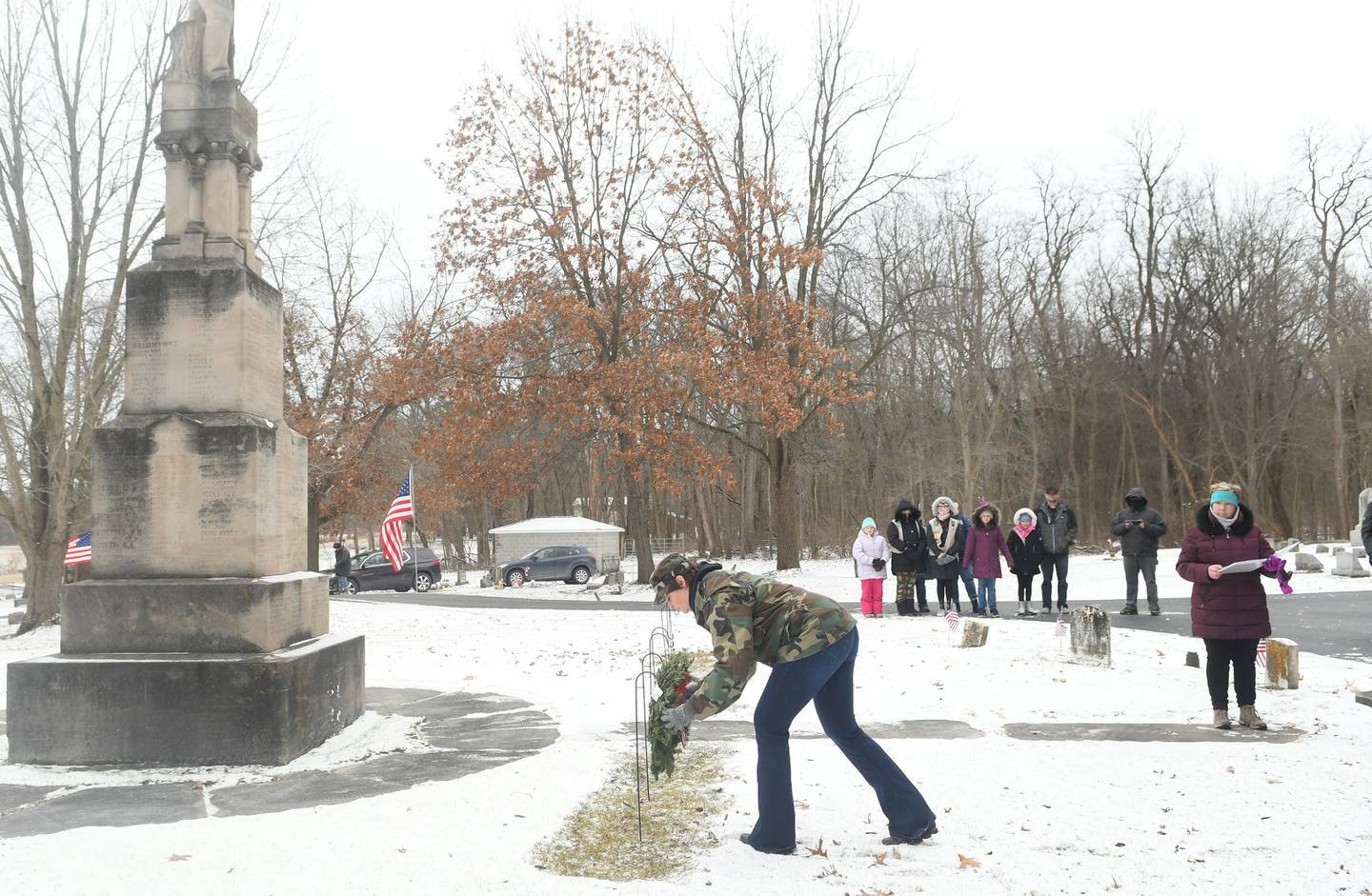Erin Dietrich of Oregon, an Army veteran, lays a wreath in honor of Army veterans, at Daysville Cemetery on Dec. 17 during the Wreaths Across America project. Wreaths were then placed on veterans' graves by other volunteers and veterans.