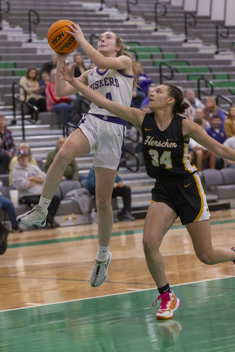 Macy Mahler of Serena High School jumps into a layup against a Herscher athlete during the Falcon-Irish Girls Basketball Tournament on November 19, 2024 at Seneca High School.