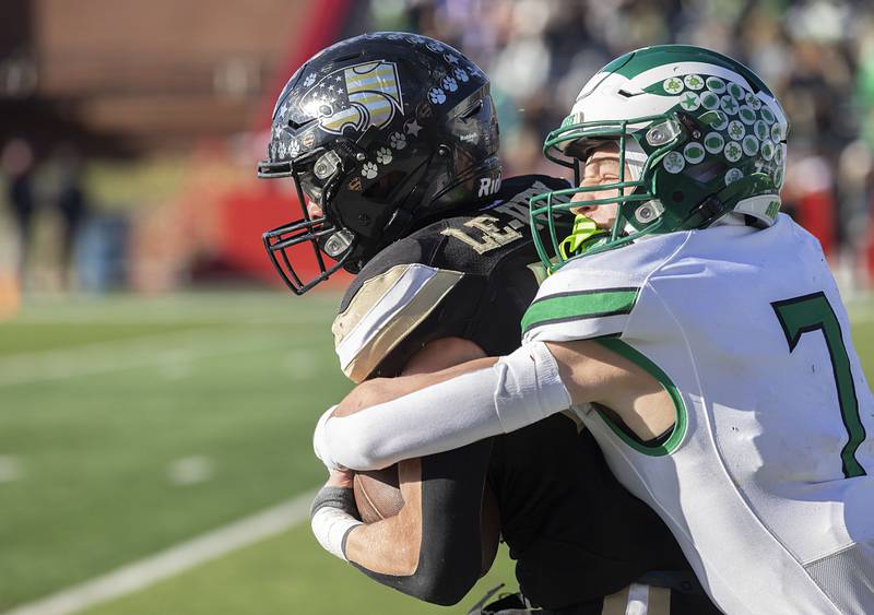 Lena-Winslow’s Alec Schlichting is tackled by Brown County's Jack Sefton riday, Nov. 28, 2025, in the Class 1A football finals at Hancock Stadium at ISU.