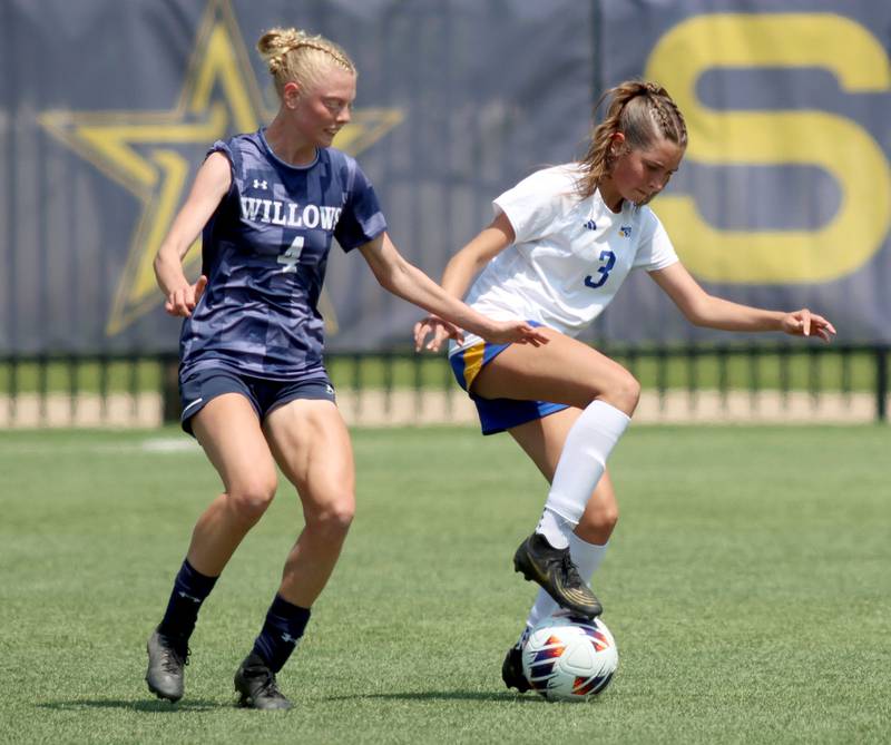 Johnsburg’s Charlie Eastland, right, maneuvers around Willows Academy’s Bernadette Presberg  in IHSA Class 1A Supersectional soccer action at Dominican University in River Forest on Saturday, May 31, 2025.