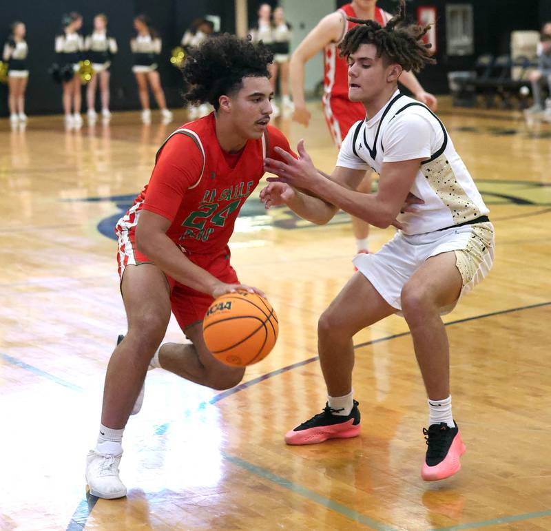La Salle-Peru's Marion Persich drives against Sycamore's Josiah Mitchell during their game Tuesday, Feb. 4, 2025, at Sycamore High School.
