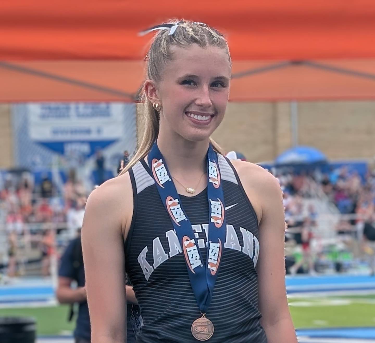 Kaneland's Delainey Baran smiles on the awards stand after finishing sixth in Class 2A in the pole vault during the IHSA Girls Track and Field State Meet on Saturday, May 23, 2026, at Eastern Illinois University in Charleston.