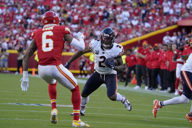 Chicago Bears wide receiver DJ Moore runs with the ball as Kansas City Chiefs safety Bryan Cook defends during the second half, Sunday, Sept. 24, 2023, in Kansas City, Mo. (AP Photo/Ed Zurga)