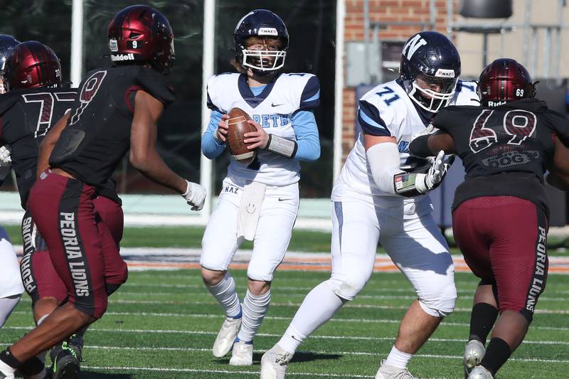 Nazareth's Logan Malachuk looks for a receiver in the Peoria secondary during their IHSA Class 5A state championship game Saturday, Nov. 26, 2022, in Memorial Stadium at the University of Illinois in Champaign.