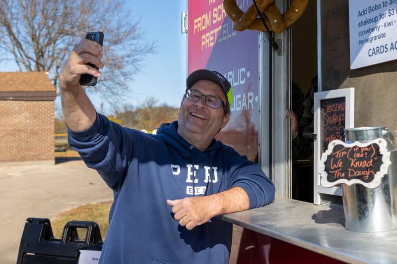 Peru Mayor Ken Kowalski takes selfie with Didoughs employee at the annual trick or treat at Washington park on Saturday, October 26, 2024 in Peru.