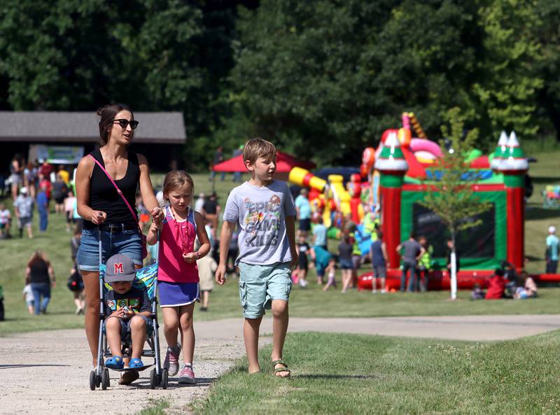 Kylie Porter of Marengo walks with her children Cash, 3, Sawyer, 8, and Saylor, 6, during A Day in the Park hosted by the Marengo Park District Saturday at Indian Oaks Park in Marengo.