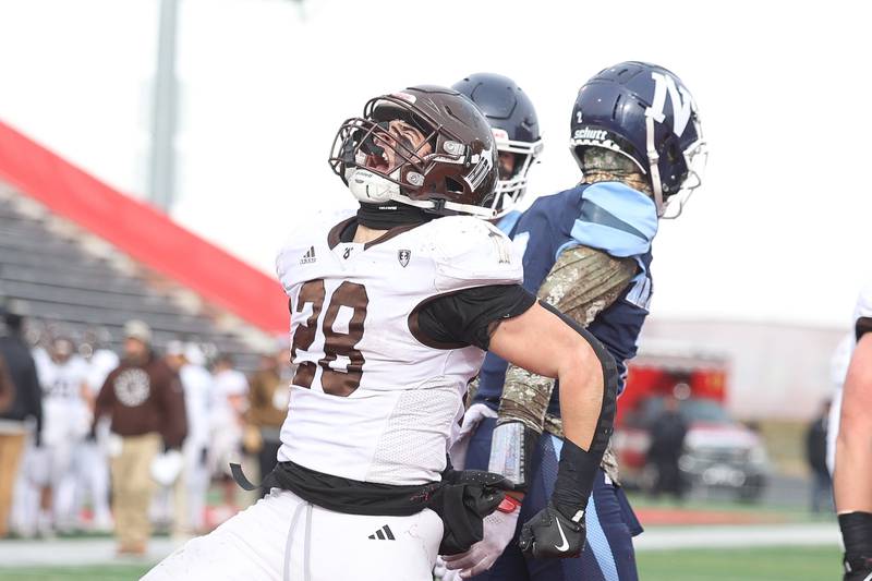 Joliet Catholic’s Nate Magrini celebrates a touchdown run against Nazareth in the Class 5A state championship on Saturday, Nov. 30, 2024 in Normal.