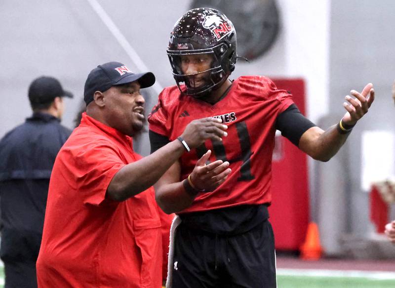 Northern Illinois football head coach Thomas Hammock talks to quarterback Jalen Macon during the first spring football practice Thursday, March 27, 2025, in the Chessick Practice Center at NIU in DeKalb.