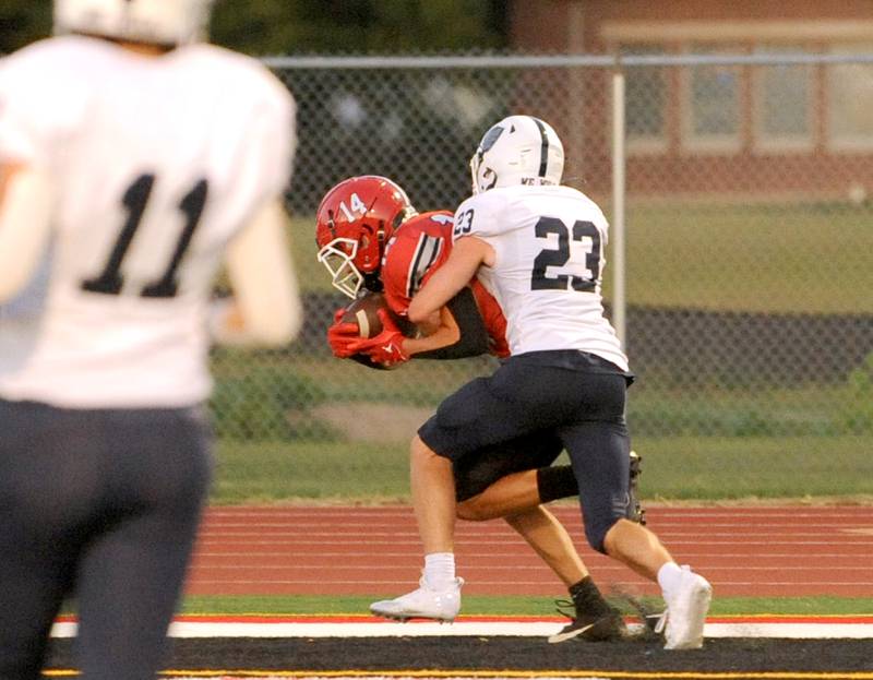 Yorkville wide receiver Eli Walton (14) secures a pass against New Trier defender Jameson Rick (23) for a touchdown during a varsity football game at Yorkville High School on Friday, Sep. 1, 2023.