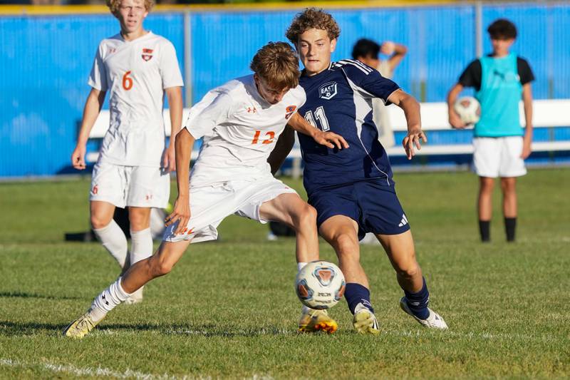 Oswego’s Vilius Adulcikas (12) challenges Oswego East's Vakaris Majus (11) for the ball during a Southwest Prairie Conference game at Oswego East High School on Thursday, Sept. 25, 2025.
