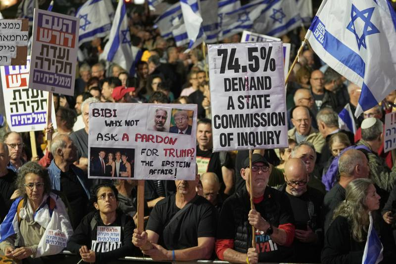 People take part in a protest against Prime Minister Benjamin Netanyahu's government and call for a state commission of inquiry to investigate the events of the Hamas militant group attack of October 7, 2023, as they gather at Habima square, in Tel Aviv, Israel, Saturday, Nov. 15, 2025. (AP Photo/Mahmoud Illean)