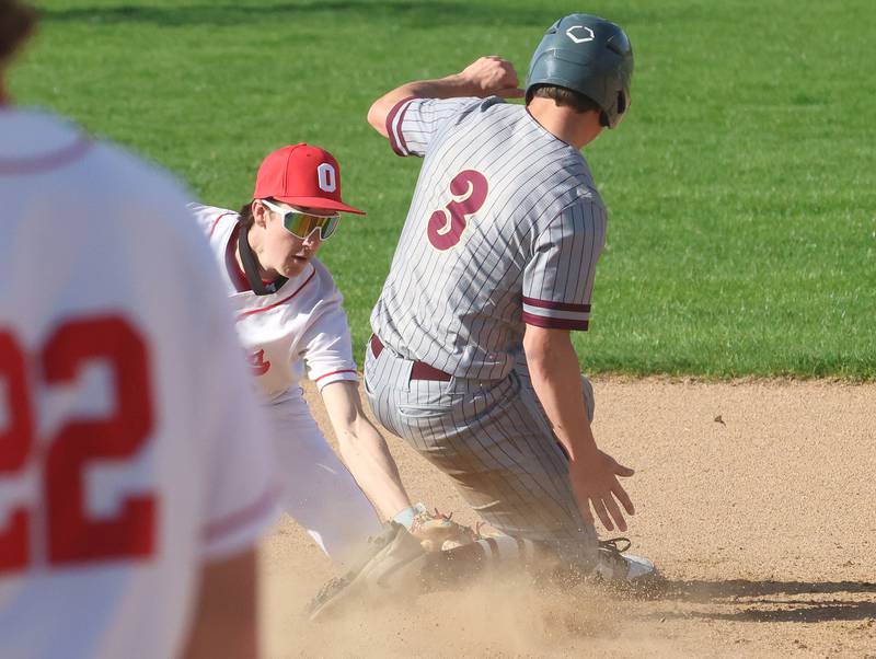 Ottawa's Colt Bryson tags out Morris's Logan Conroy sliding into second base on Monday, April 20, 2026 at Ottawa High School.